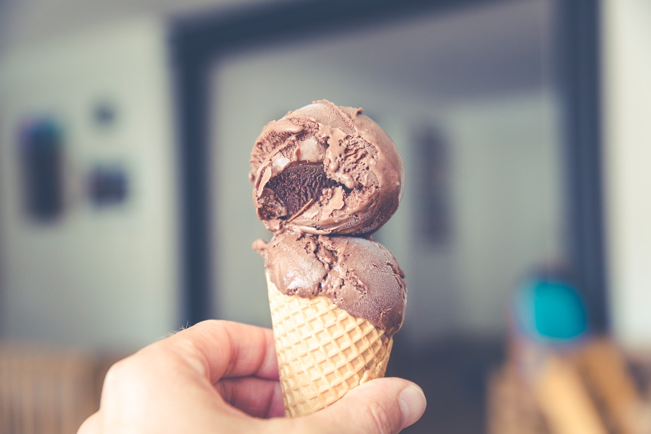 A chocolate soft serve cone